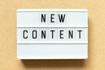 Poster - Lightbox with word new content on wood background