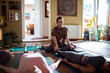 © Marko Geber - Young and diverse group of female friends doing yoga together in the living room at home