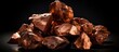 Copper nuggets on black background used in industry for electrical wires and household utensils