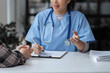 © crizzystudio - Asian female doctor using a stethoscope to examine a patient, ask for information, give advice, comfort, plan a course of treatment and preventive care. concept of health check