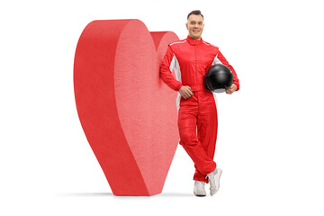 Wall Mural - Racer leaning on a red heart and holding a helmet