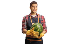 Farmer holding a watermelon and smiling