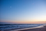Fototapeta  - the moon on a clear beautiful early evening on an empty Amagansett, NY beach
