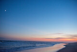 Fototapeta Nowy Jork - The moon and  sunset over a beach in the hamptons