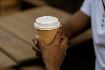 Wall Mural - close up person's hand giving a coffee to a friend, taking care