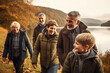 © Bojan - Multi generation family walking by lake on countryside.