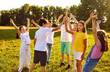 © Studio Romantic - Happy children friends standing together outdoors, having fun and smiling in the park on holidays enjoying spending time in a summer camp. Portrait of a kids having weekend activity.