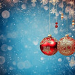 2 Christmas baubles hanging down over a light blue snowy background with copy space on the left