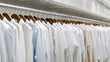 White shirts hanging on white built-in cloths racks.generative ai