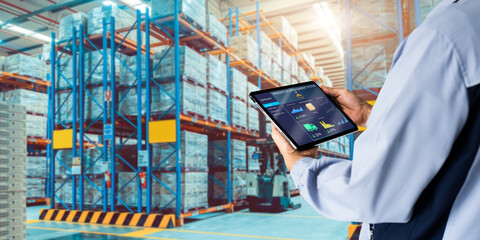 smart warehouse,inventory management system concept.manager using digital tablet,showing warehouse s