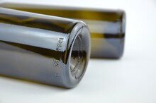 Two Dark Green (olive) Wine Bottle Bottoms On A White Background, Closeup, Side View