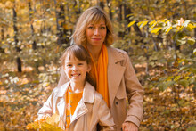 Beautiful Lifestyle Autumn Photo Mother And Child Walks Evening In The Park, Warm Sunlight.