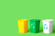 Leinwandbild Motiv Containers for garbage on green background. Recycling concept