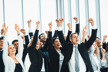 Wall Mural - Successful business people standing together showing strong relationship of worker community. A team of businessman and businesswoman expressing a strong group teamwork at the modern office. Jivy