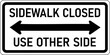 Vector graphic of a black Sidewalk Closed MUTCD highway sign. It consists of the wording Sidewalk Closed, Use Other Side and a horizontal arrow contained in a white rectangle
