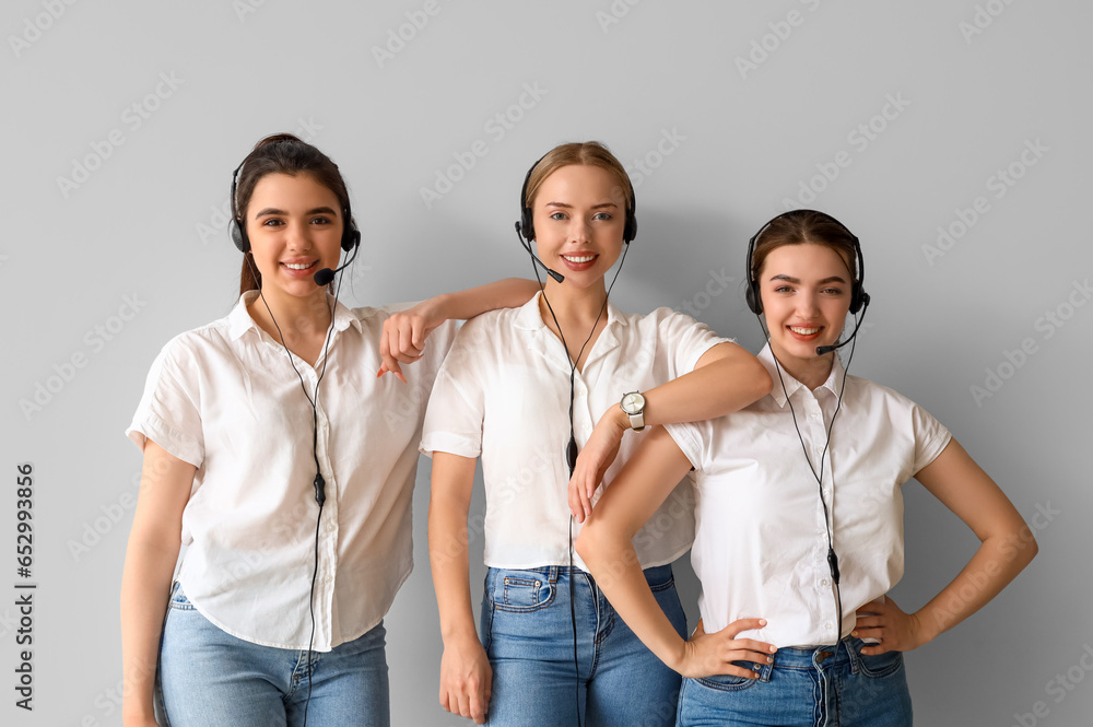 Female technical support agents on light background