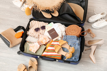 Canvas Print - Suitcase with clothes, beach accessories, passport and tickets on floor. Travel concept