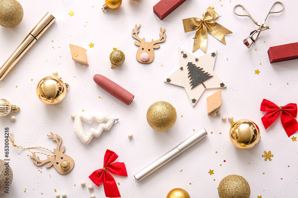 Composition with decorative cosmetics and Christmas decor on white background