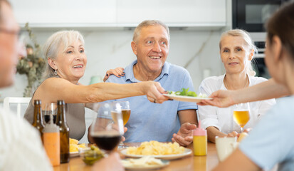 Wall Mural - Happy elderly friends spending free time together in kitchen of a nursing home - having lunch and chatting