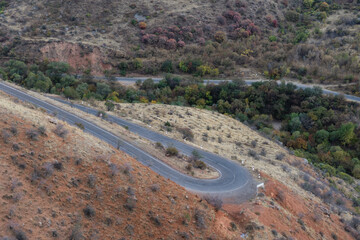 Autumn mountain landscape with colorful forest and road 