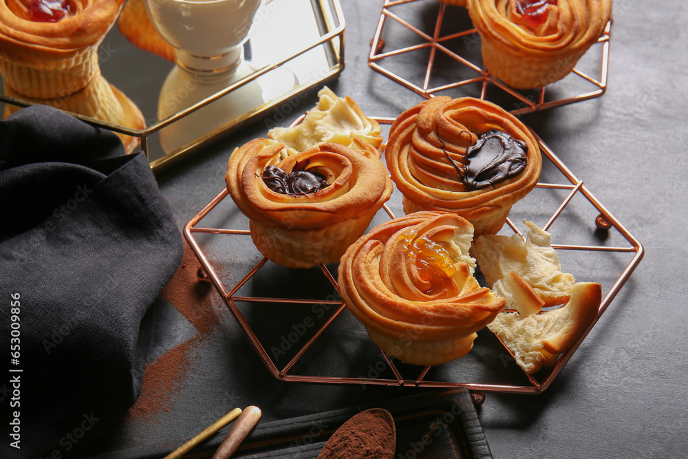 Grid of tasty cruffins with chocolate and jam on black background