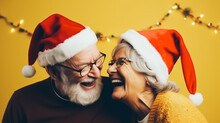 Older Loving Couple With Santa Hats Joyfully Hugging And Kissing, Minimal Ochre Background. Sincere Joy Of Christmas Holidays. Generative AI.