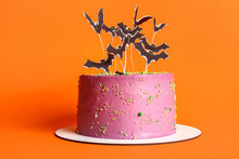 Tasty Cake Decorated For Halloween On Orange Background