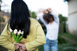 © Erika - Young man surprises his girlfriend with bunch of flowers