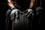 Fototapeta Mapy - New car tires and the hands of a master. Background with selective focus and copy space
