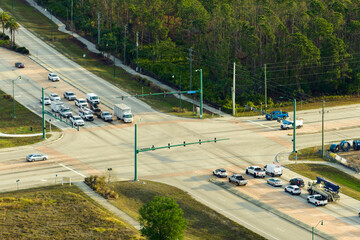 Wall Mural - Aerial view of wide multilane road with moving cars at intersection with traffic lights. City transportation in the USA. American urban traffic from above