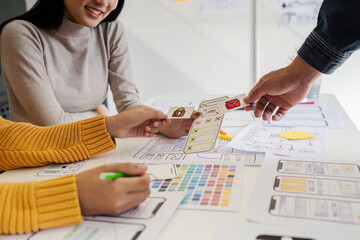 Wall Mural - team of ui ux web designer are working together to develop mobile responsive websites with ui ux fro