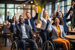Disabled multiracial businesswomen and businessmen with disability in wheelchair and her colleagues partners celebrating end of work team together on project. Teamwork in diverse office concept