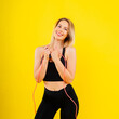 © Ivan Zelenin - Blond woman with jump rope in studio, yellow red and dark background