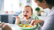 © catalin - a baby comfortably sitting in a high chair, eagerly eating a colorful plate of mashed fruits and vegetables, as a parent lovingly feeds them with a small spoon
