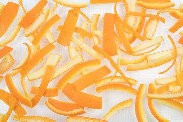 Wall Mural - Single orange peel on a white background. Vitamin C, beauty health skin concept.