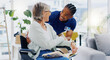 © Wesley JvR/peopleimages.com - Black man, caregiver or old woman in wheelchair talking or speaking in homecare rehabilitation together. Medical healthcare advice or male nurse nursing or helping elderly patient with disability