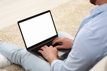 Poster - Man using laptop on floor indoors, closeup view