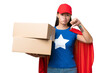 © luismolinero - Super Hero delivery Asian woman holding boxes over isolated background showing thumb down with negative expression