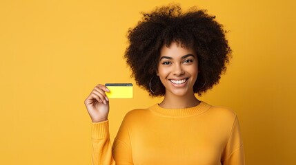 Happy young afro woman showing credit card