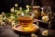 a brewed cup of chamomile tea on a wooden table