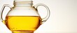 Cooking oil poured from pitcher onto white background