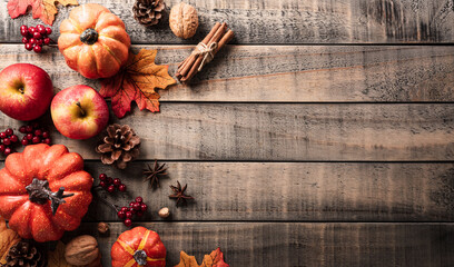 Wall Mural - autumn and thanksgiving decoration concept made from autumn leaves and pumpkin on dark wooden backgr