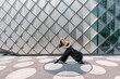 © VISTA by Westend61 - Dancer dancing in front of modern building