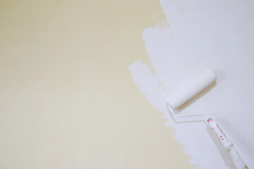 Wall Mural - Roller Brush Painting, Worker painting on surface wall  Painting apartment, renovating with white color  paint. Leave empty copy space to write descriptive text beside.