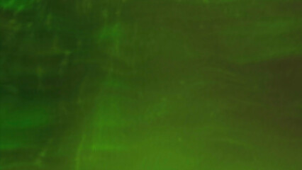 Wall Mural - Green background with magic dust. Motion. Small illuminated particles flying in different directions in abstraction.