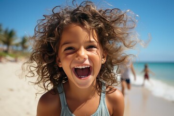 Wall Mural - Vacation concept. A happy little girl with curly hair has fun on a sandy beach in the summer. space for text. children's summer holidays