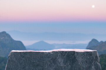 Surreal stone podium outdoors on sky pink pastel soft cloud sunrise with misty mountain nature landscape background.cosmetic product placement pedestal present minimal display,paradise dreamy concept.