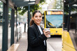 © Andrei - Beautiful young multiracial hispanic business woman using public transportation in city smiling and holding eco thermo cup with coffee