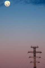 Wall Mural - High voltage post with full moon at sunrise. Minimalism.