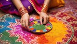 Indian woman with colorful holi powder in bowl